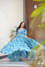 Load image into Gallery viewer, Full flair sky blue gown with rich printed fabric , Best-selling sky blue gown for wedding guests , Comfortable sky gown with half sleeves and lining , Sky printed gown with modern ethnic detailing , Classic sky blue gown with cotton inner .
