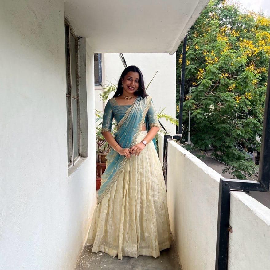 Light sky tissue silk half saree design , Light sky lehenga with embroidery voni , Elegant light blue tissue silk lehenga , Light sky half saree in South Indian style , Tissue silk lehenga choli light sky color , Soft sky blue lehenga with zari work , Light sky voni with cutwork border , Festive wear lehenga in light sky tone .