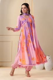 Purple or Orange Fatema Muslin Anarkali is made from soft muslin with a digital shine print. It features a V-neck, full sleeves, and a length of 52-55 inches. The set includes one gown and a dupatta, and it is easy to care for with machine wash and Traditional Look For Anarkali 2025-26 .
