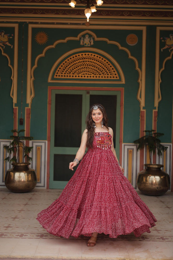 Maroon Faux Georgette Gown With Price and Online Best Shopping Price Under 1500 . This Fabric Bandhani Print work and kutchi patchework in Faux Georgette Fabric So Heavy Gown . this Fabric Gown Experience elegance with this Faux Georgette Gown. Complete with exquisite  short cutwork sleeves, and full cotton lining, it’s a timeless piece for festive or formal occasions.