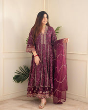 Elegant 3-piece suit set crafted from heavy rayon mill foil print fabric, featuring hand embroidery, zari weaving, and intricate lace dupatta. Available in stunning red and maroon shades . 