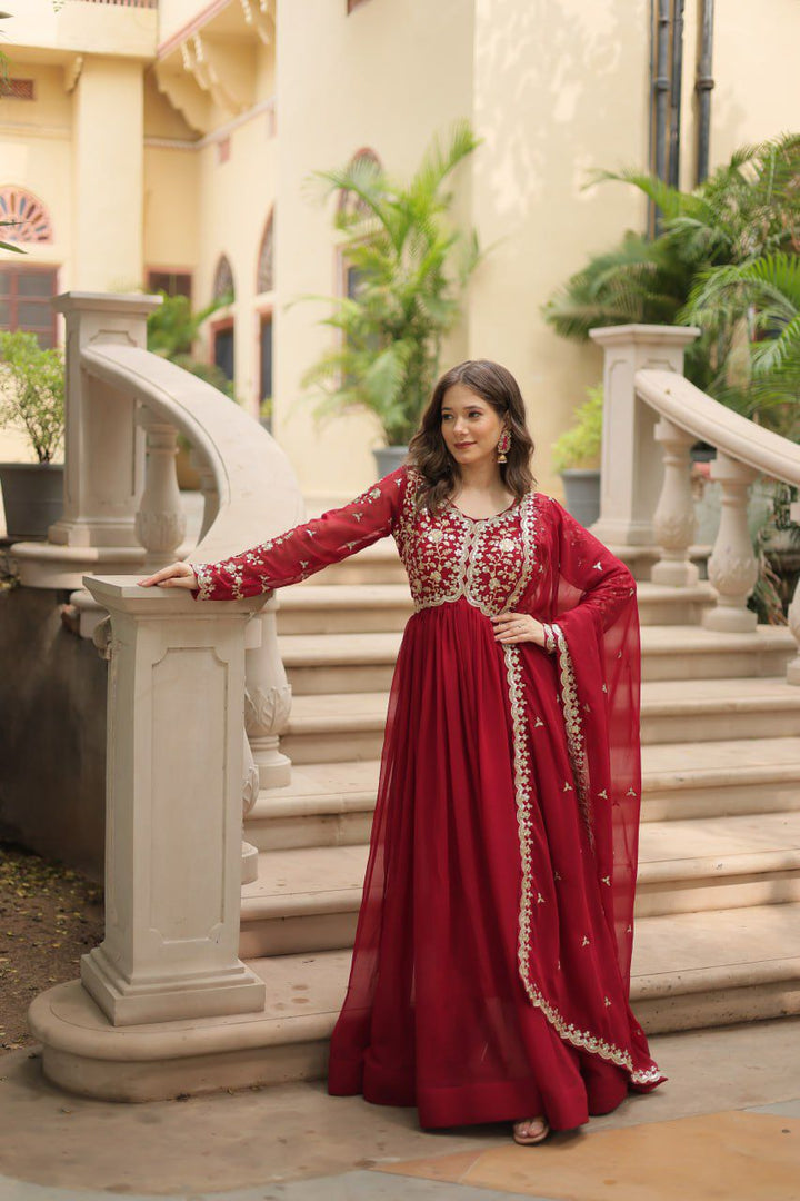 Maroon Or Red Color Faux Blooming Anarkali With Price and Online Shopping Price Under 1500 . this Fabric Maroon Color Faux Blooming Fabric Top Side Fancy Neck , Lengths 56 inch , Cotton Lining and Dupatta Faux Blooming Georgette With Rich Sequins Multi Embroidered Lace Border . Traditional Look For 2024-25 , 2025-26 . 