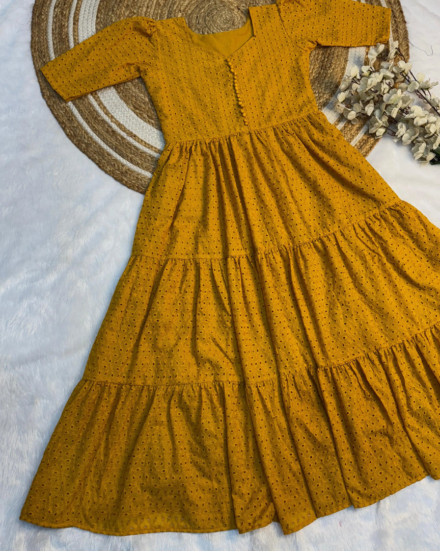 Mustard Yellow Color Cotton Hakoba Fully Fair and Plain Gown . Summer special yellow gown with flared cotton layers , Trendy yellow mini frock in soft Hakoba cotton , Elegant yellow 3-layer gown with stylish side detailing , Yellow designer gown with rope tie-up and full lining .