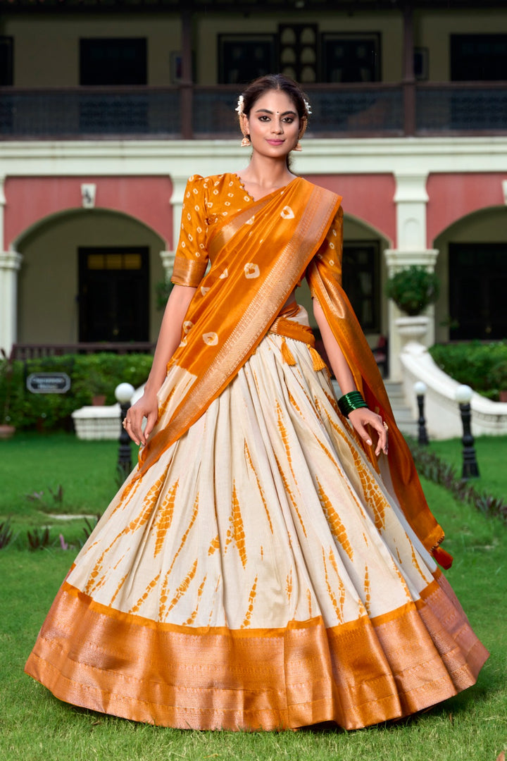 Wedding function lehenga in beautiful Orange shade , Stylish Shibori Print Orange Lehenga with flair , Orange Dola Silk Lehenga with golden detailing , Shop Orange lehenga for traditional occasions , Elegant Orange bridal lehenga with classic touch . Orange lehenga for sangeet, reception or party wear.
