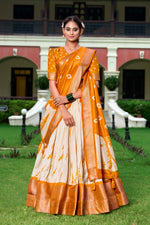 Load image into Gallery viewer, Orange Dola Silk Lehenga with golden detailing , Shop Orange lehenga for traditional occasions , Elegant Orange bridal lehenga with classic touch , Orange lehenga for sangeet, reception or party wear . 
