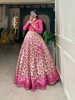 Load image into Gallery viewer, This stitched Meena Dola Silk Lehenga features floral print with sequins and a zari border, crafted from Dola Silk for a rich look.
