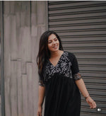 Load image into Gallery viewer, Elegant black georgette kurti with delicate embroidery , Partywear black embroidered kurti with V-neck style , Black half sleeve georgette kurti for women , Designer black kurti for festive and formal wear , Soft georgette kurti in black with classy finish . 

