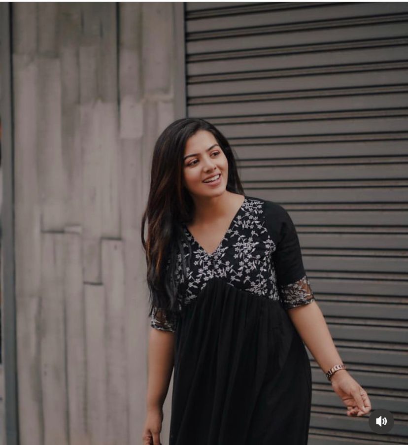Elegant black georgette kurti with delicate embroidery , Partywear black embroidered kurti with V-neck style , Black half sleeve georgette kurti for women , Designer black kurti for festive and formal wear , Soft georgette kurti in black with classy finish . 