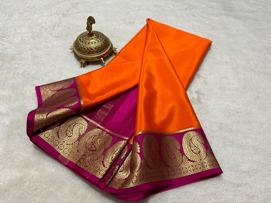 Discover the refined elegance of our Sapana Semi-Mysore Silk Saree, a masterpiece of traditional textile craftsmanship. This exquisite 6.3-meter saree showcases the distinctive qualities of Semi-Mysore Silk—known for its balanced weight, subtle sheen, and exceptional durability that withstands the test of time. The saree features meticulous zari weaving,