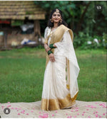 Load image into Gallery viewer, Soft organza Onam saree (6.3m) featuring check pattern with zari border. Includes puff half sleeves. Machine washable. One gown piece included.

