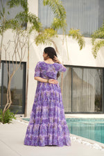 Load image into Gallery viewer, Designer purple gown stitched with full inner , Fancy purple gown with stunning half sleeves , Rich purple faux georgette gown for women , Traditional purple gown with vibrant floral print .
