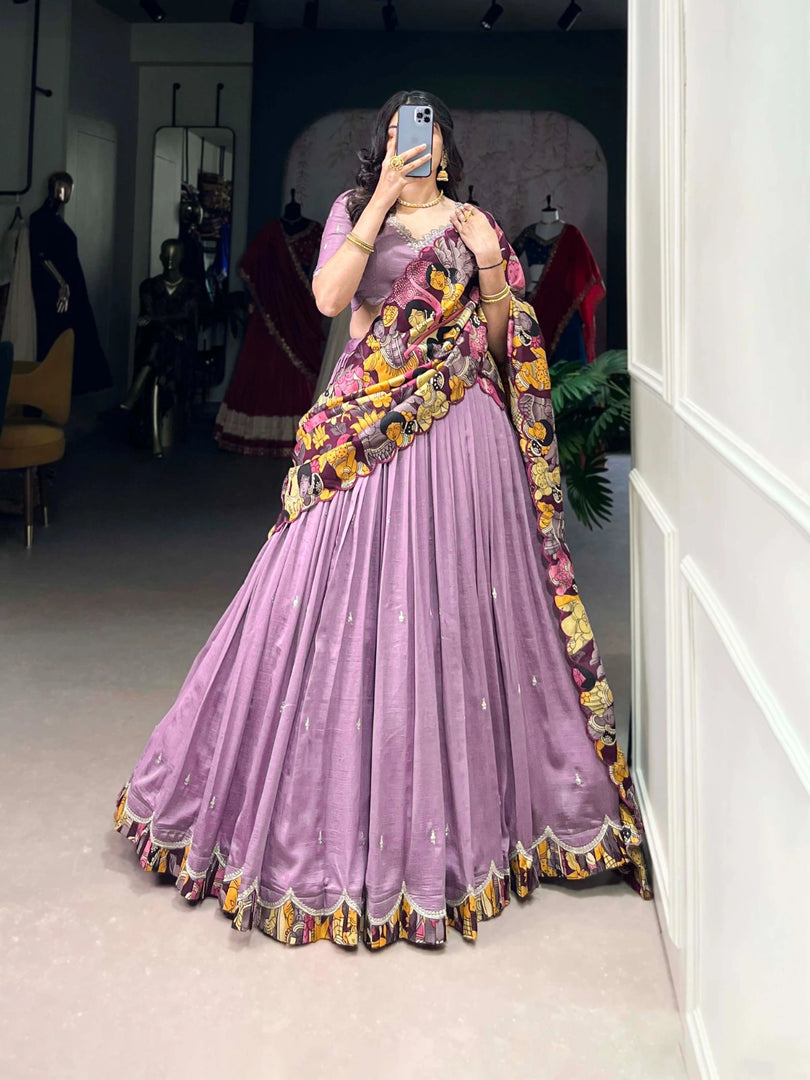 Purple Vichitra Silk lehenga with embroidery , Kalamkari border lehenga in purple color , Purple lehenga choli set for wedding , Designer purple lehenga with dupatta , Purple lehenga for festive occasion , Elegant purple silk lehenga , Purple color lehenga with can-can , Heavy embroidered lehenga in purple , Purple ethnic wear for girls , Purple traditional lehenga with tassels . 