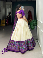 Load image into Gallery viewer, Purple Tussar Silk Dhavani set features a stitched tussar silk lehenga with Patola print, Drawstring waist and zip closure. The lehenga includes a micro cotton lining and 3.8 meters of flair. The unstitched blouse piece is tussar silk with printed design, measuring 0.8 meters. The tussar silk dupatta has a Patola print . 
