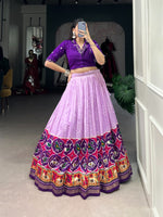 Load image into Gallery viewer, Devanshi Tussar Silk Purple Dhavani features a stitched Tussar Silk lehenga with Bandhej and Patola print, supporting waist up to 42&quot;. Includes a Pure Cotton blouse with mirror work (size 38&quot;, adjustable to 42&quot;). Complete set contains lehenga, blouse, drawstring with zip, and tassels.
