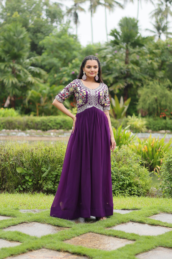 Purple Faux Blooming Gown With Price and For Weddings Price Under 1500 . this Fabric So Happy and Cool Fabric . this Fabric Faux Blooming Gown Online Best Shopping Price Under 1500 . this Fabric Best Famous and Best Popular Gown Purple Color. Purple Gown Round Neck Fully Embroidery Zari Sequins Work .