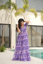 Load image into Gallery viewer, Royal purple gown in flowy faux georgette , Purple flared gown with elegant ethnic prints , Designer purple gown with 12-meter flair , 
Printed purple gown for festive occasions , Fancy purple gown with V-neck and half sleeves . 
