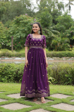 Load image into Gallery viewer, Purple Faux Blooming Gown With Price and Online Shopping Price Under 1500 . this Experience elegance with this Faux Blooming Gown. Complete with exquisite embroidery, short cutwork sleeves, and full cotton lining, it’s a timeless piece for festive or formal occasions . Traditional Look 2024-25 . 
