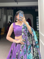 Load image into Gallery viewer, Purple Tussar silk lehenga with floral lace accents , Elegant purple lehenga with tassels and floral printed dupatta , Designer purple floral lehenga for wedding season ,  Purple lehenga with 3.8 meter flair and canvas support . 
