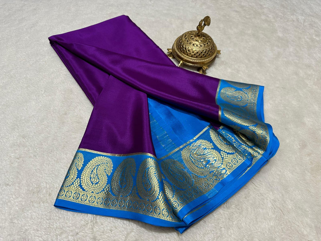 Displayed on size S model. This Semi-Mysore Silk saree features traditional zari weaving throughout its 6.3m length. Complete ensemble includes matching blouse piece. Convenient machine wash care recommended. Authentic craftsmanship with practical maintenance.