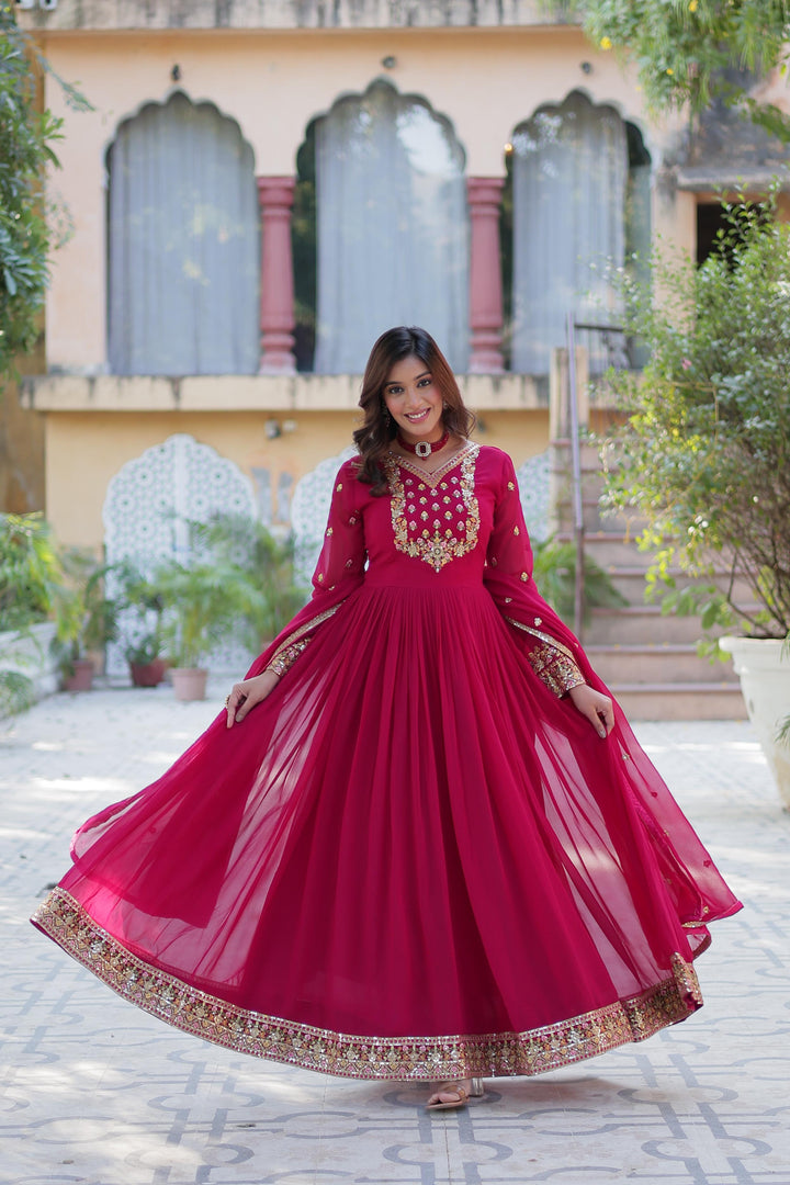 Rani Pink  Faux Blooming Georgette Gown With Prices and Online Shopping Best Price Under 2000 . This Fabric Rani Pink Faux Blooming Georgette Gown For Wedding Collection. This Fabric Heavy Embroidery work and Rich ( Premium ) Zari Weaving Work Border and Dupatta Faux Blooming Georgette With Attractive lace and embroidered work . Traditional Woman Wear Collection Look 2024-25 . 