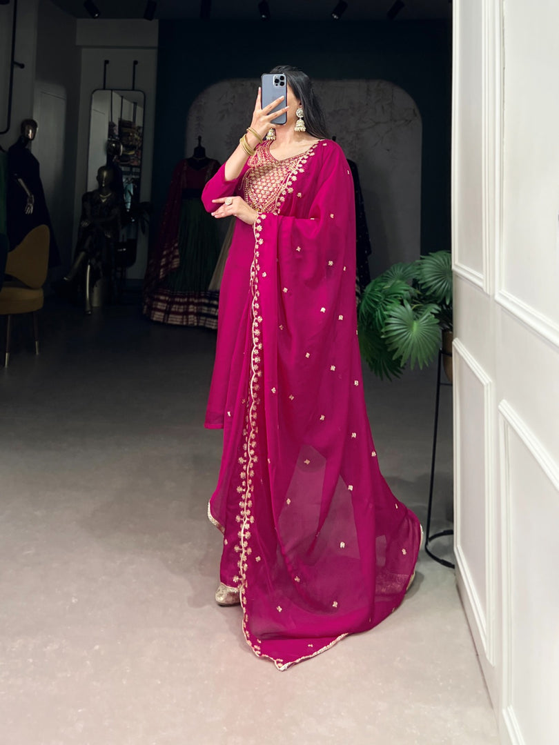 Trendy rani pink three-piece ethnic outfit , Festive kurti set in rani pink color , Rani pink ethnic wear with micro cotton lining , Fancy embroidered rani pink kurta and pant , Rani pink organza suit for wedding functions , Graceful rani pink Indian attire for women . 
