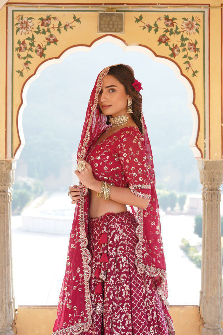 Divisha Half Saree Set includes a full-stitched lehenga made of pure viscose jacquard with embroidered sequins and a chain with dori latkan closure. The unstitched blouse is made from faux blooming fabric with sequined embroidery. 