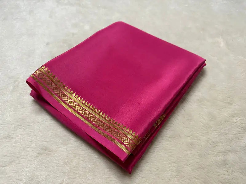 Elegant Rani Pink Semi-Mysore Silk Saree featuring zari weaving. Includes matching blouse piece. 6.3m length. Machine washable. Available in 6.3M.
