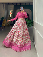 Load image into Gallery viewer, Soft pink lehenga in Dola silk with floral motifs , Printed pink lehenga with sequin and zari highlights , Designer stitched pink lehenga with blouse , Pink lehenga with handcrafted tassels and zip , Elegant pink lehenga for wedding or reception , Plain pink banglory blouse with stylish full sleeves. 
