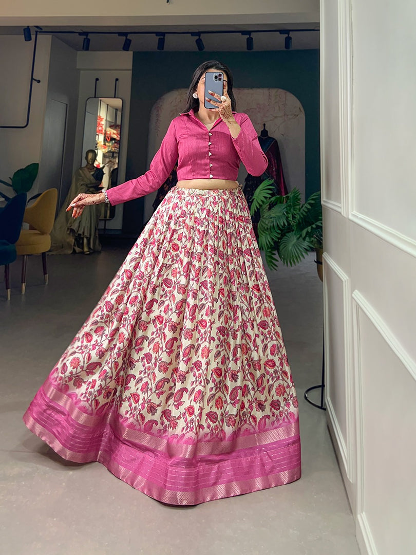 Soft pink lehenga in Dola silk with floral motifs , Printed pink lehenga with sequin and zari highlights , Designer stitched pink lehenga with blouse , Pink lehenga with handcrafted tassels and zip , Elegant pink lehenga for wedding or reception , Plain pink banglory blouse with stylish full sleeves. 