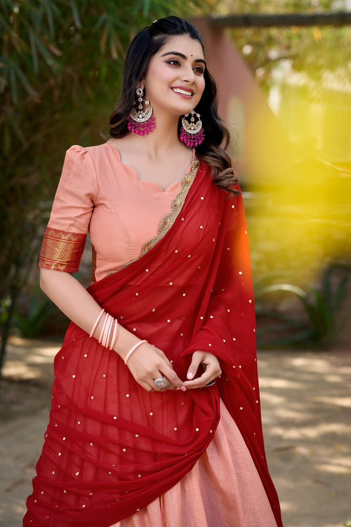 Cotton Silk Dhavani set featuring stitched lehenga with thread embroidery (3.5m flair), unstitched blouse with zari work, and Georgette dupatta with sequin embroidery. Traditional Dhavani Set - shop now Shoppers Trend...

