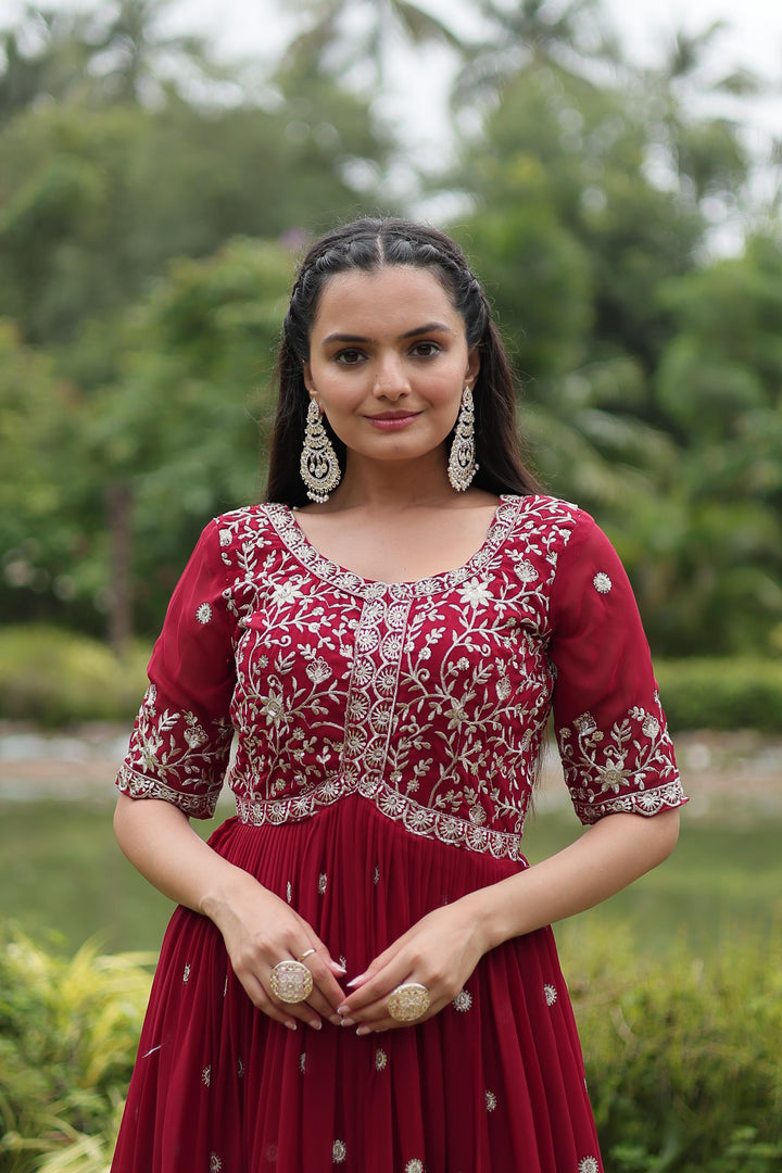 Red color gown with inner lining comfort , Designer red gown stitched for elegance , Glam red ethnic gown with graceful flair , Wedding favorite red gown in faux blooming price under 1399 . 