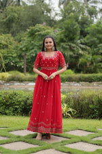 Load image into Gallery viewer, Red Color Faux Blooming Gown With Price and Best Wedding Collection Price Under 1500 .this Fabric Grace your events with this stunning Faux Blooming Gown. Highlighting intricate zari-sequins embroidery, a square neck, and a 3.5-meter flair, it offers unmatched style and comfort , Traditional Look For 2024-25 , 2025-26 . 
