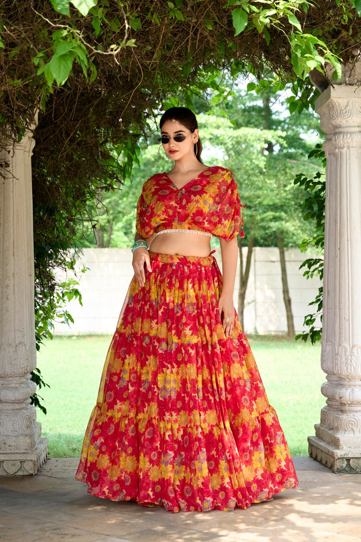Ready-to-wear red lehenga with floral charm and rich color , Shop full-stitched red lehenga with pearl blouse online , Statement-making red lehenga with traditional flair , Elegant red chiffon lehenga set for Indian ceremonies , Flowing red lehenga with zip closure and printed blouse . 