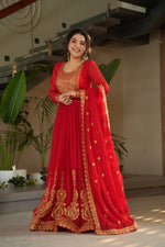 Load image into Gallery viewer, Red gown and dupatta set for celebrations , Classic red gown with 3.5-meter flair , Heavy embroidered red gown for functions , Ethnic red gown in faux blooming fabric , Red color long gown with zari sequin  detailing ...

