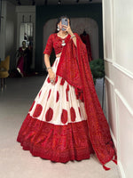Load image into Gallery viewer, Silk red lehenga with drawstring and heavy tassels , Vibrant red lehenga in Bandhani style for party looks , Eye-catching red Tussar silk lehenga for Indian celebrations , Traditional red lehenga with modern festive appeal . 
