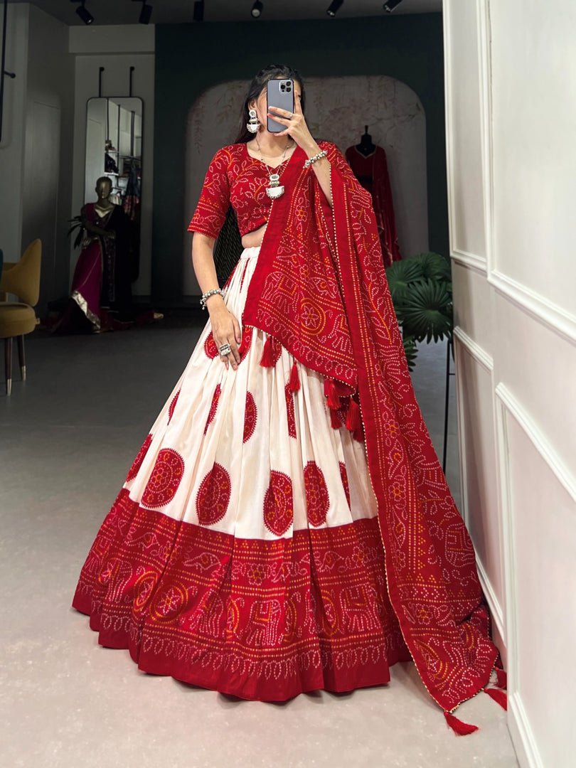 Silk red lehenga with drawstring and heavy tassels , Vibrant red lehenga in Bandhani style for party looks , Eye-catching red Tussar silk lehenga for Indian celebrations , Traditional red lehenga with modern festive appeal . 