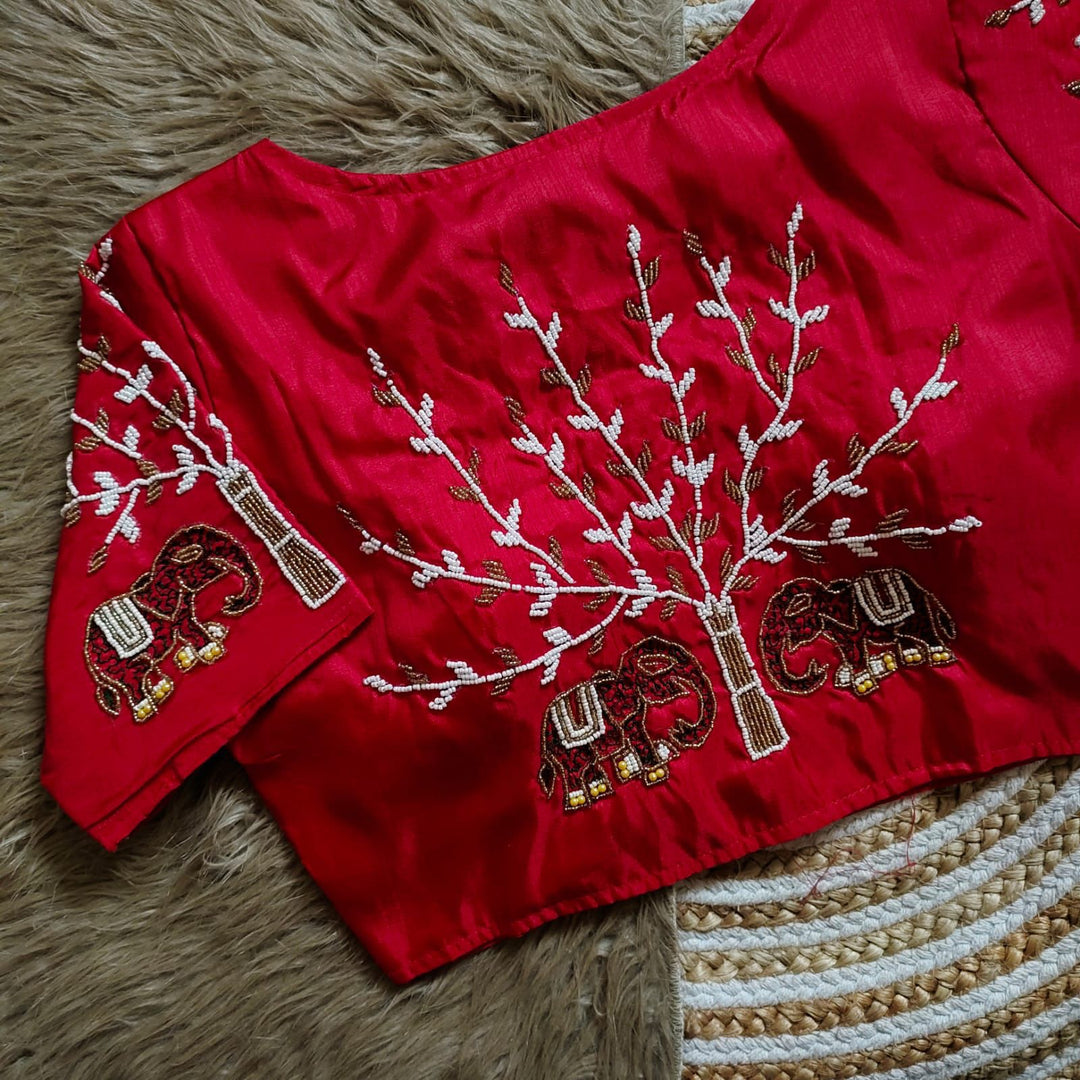 Red Haka Silk Stitched Blouse With Price and Online Shopping Price Under 1500 . This Fabric Red Color Haka Silk Stitched Blouse trees Embroidery work and Elephant Design and Sleeve 10 Inch and Height !5 Inch and Traditional Wear And Wedding Wear Collection , Traditional Look 2025-26 . 