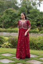 Load image into Gallery viewer, Bridal red gown with zari and sequin work , Faux blooming red gown for weddings and events , Elegant red embroidered gown with cotton lining , Half sleeve red gown for festive occasions , Red color ethnic gown with 3.5 meter flair . 
