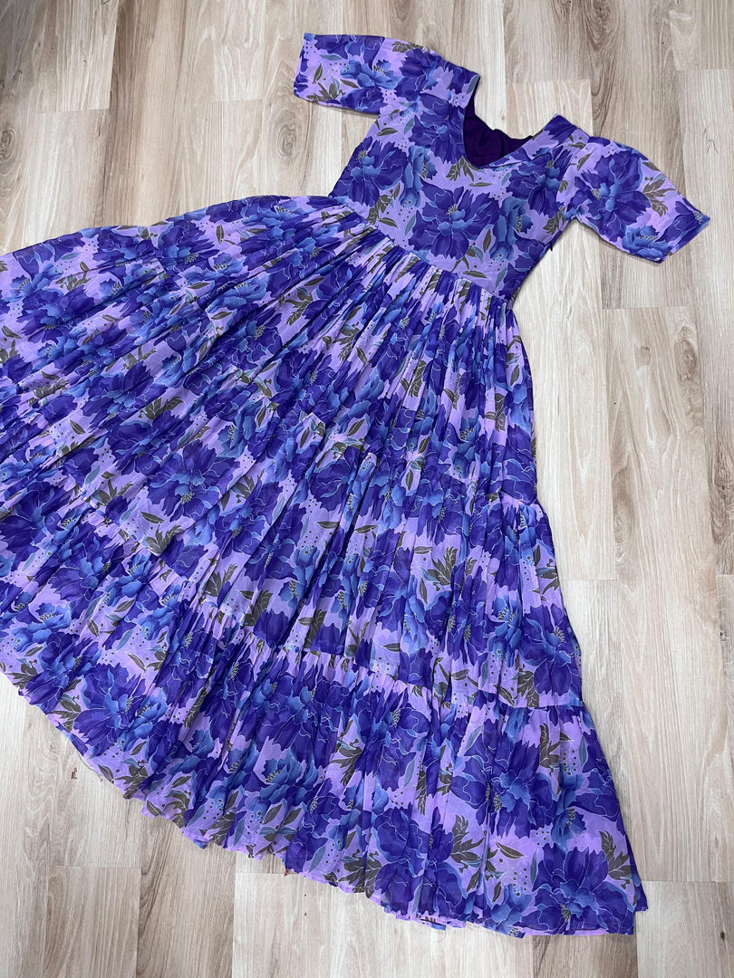 Trendy sky blue gown with subtle floral print , Sky color ethnic gown with designer sleeve style , Full flair sky blue gown with rich printed fabric , Best-selling sky blue gown for wedding guests , Comfortable sky gown with half sleeves and lining . 