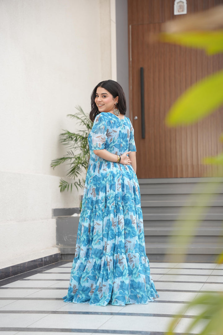 Sky blue georgette gown with full 12-meter flair , Elegant sky color gown with fancy V-neck design , Sky color party gown in soft faux georgette fabric , Lightweight sky gown for reception and festive look .