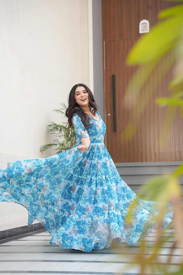 Sky Color Printed faux georgette gown with cotton lining. 56" length, 12m flair, half sleeves, fancy V-neck. Ready-to-wear Gown price Under 1499 . 