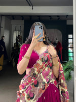 Load image into Gallery viewer, Wine Color Made from luxurious Vichitra Silk fabric, this stitched Lehenga is designed with intricate Sequins and Thread Embroidery Work, and features a beautiful Kalamkari Print Border. - The Micro Cotton Inner provides a comfortable fit and allows for a graceful 4 Meter flair. - The Tussar Silk Dupatta is adorned with stunning Kalamkari Print and Foil Work.
