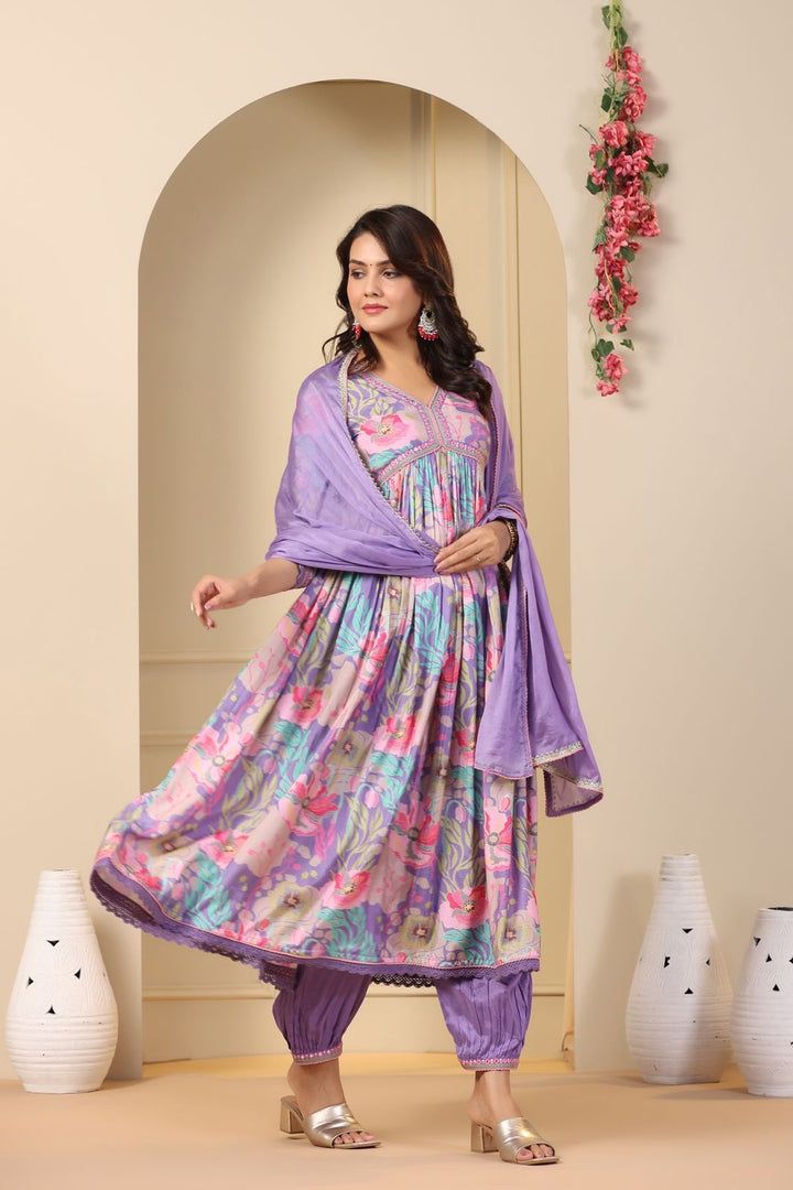 This purple Anarkali set features cotton maslin fabric with digital shine print embroidery. It includes a gown, pant, and dupatta, with a V-neck and full sleeves. The length is 52-55 inches. Easy to care for with machine wash. Available in size S.
