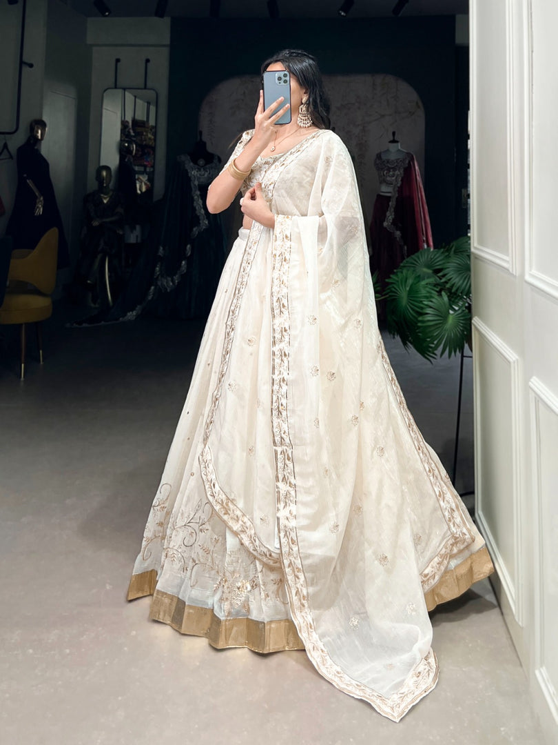 Silver Glossy Lehenga with Foil Embroidery Work , Party Wear Silver Lehenga with Dupatta , Metallic Silver Lehenga for Wedding & Reception , Designer Silver Embroidered Lehenga Set , Shiny Silver Lehenga with Sequins & Can Can Flair . 