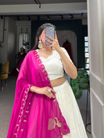 Load image into Gallery viewer, White Georgette Dhavani Set with Rani Georgette Dupatta , Elegant rani color Dupatta with Lucknowi paper mirror work . Georgette rani lehenga with sequins embroidered dupatta Designer White stitched lehenga set with canvas and cancan , Premium rani georgette lehenga with thread and mirror detailing . 
