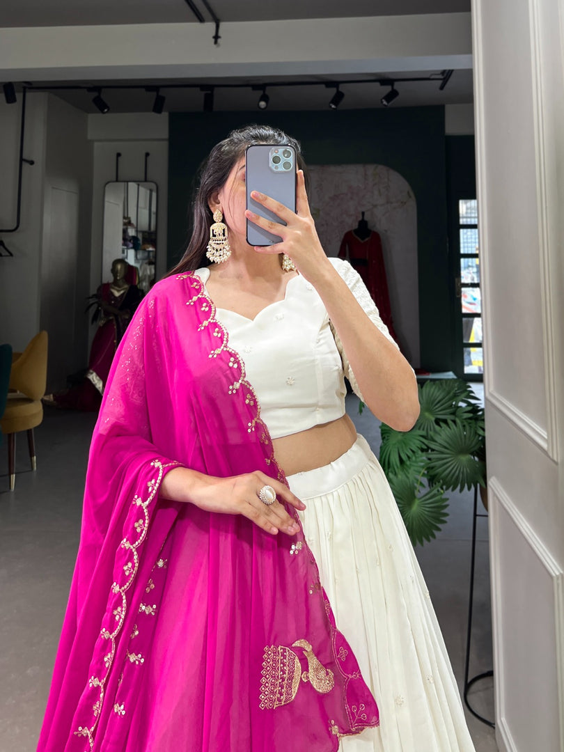 White Georgette Dhavani Set with Rani Georgette Dupatta , Elegant rani color Dupatta with Lucknowi paper mirror work . Georgette rani lehenga with sequins embroidered dupatta Designer White stitched lehenga set with canvas and cancan , Premium rani georgette lehenga with thread and mirror detailing . 
