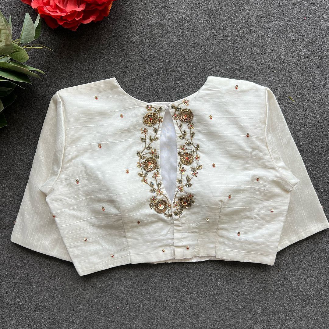 White Elzara Silk Stitched Blouse With Price and Online Shopping Price Under 1000 . this Fabric Elzara Silk back Embroidery work and Embroidery work Dotted Work , this Stitched Blouse Sleeve 10 Inches and Best For Weddings Wear Collection . 