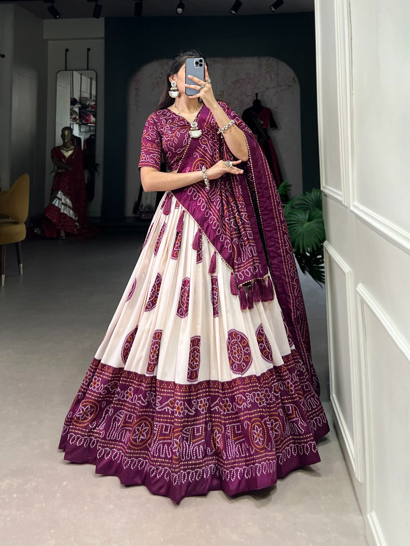 Wine Tussar silk lehenga with handcrafted drawstring closure , Elegant wine color ethnic lehenga for bridal and party wear , Premium wine lehenga with can-can and micro cotton lining , Bandhej printed wine lehenga with zari lace and tassel dupatta , Wine color wedding special lehenga with traditional touch . 