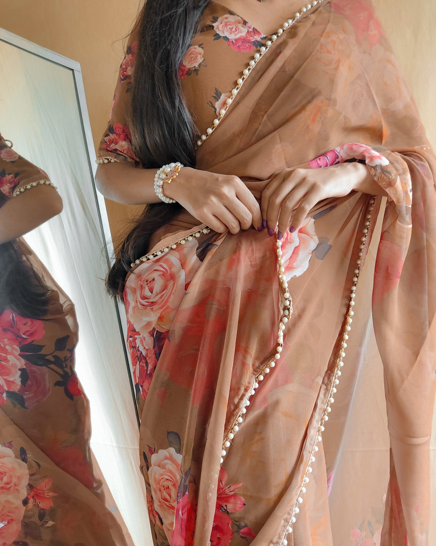 Priyanka Georgette Saree. Crafted from premium georgette fabric, this saree features intricate zari weaving that catches the light with every movement. The generous 6.3-meter length provides ample fabric for creating elegant pleats and drapes. This saree comes complete with a matching blouse piece .