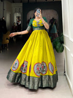 Load image into Gallery viewer, Yellow Color Dola Silk Gown With Green Koti Color For Weddings Best Wear Collcetion and Heavy Border Price and Online Shopping Price Under 1500 . Discover the beauty of Dola Silk with our stitched gown and koti set. Soft micro cotton lining and intricate Kalamkari print
